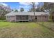 View of a large backyard featuring a home with a screened in porch at 13289 Joy Path, Brooksville, FL 34601