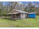Fully fenced backyard with a covered porch and storage shed at 13289 Joy Path, Brooksville, FL 34601