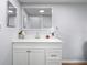 Bathroom featuring a sleek white vanity with ample counter space, a large mirror, and modern fixtures at 13289 Joy Path, Brooksville, FL 34601