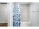 Bathroom featuring tub and shower combo with blue and white curtain at 13289 Joy Path, Brooksville, FL 34601