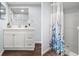 Bathroom featuring a vanity with ample counter space and shower with decorative curtain at 13289 Joy Path, Brooksville, FL 34601