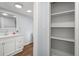 Bathroom with a bright vanity, mirror, and spacious linen closet, offering both style and practical storage solutions at 13289 Joy Path, Brooksville, FL 34601