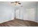 Neutral bedroom with wood-look floors and large closet for storage at 13289 Joy Path, Brooksville, FL 34601