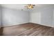 Bright bedroom featuring laminate flooring, a ceiling fan, and a closet with bi-fold doors at 13289 Joy Path, Brooksville, FL 34601