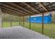 Backyard deck showcasing the backyard with an outbuilding and chainlink fence at 13289 Joy Path, Brooksville, FL 34601