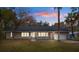 Charming single-story home featuring a welcoming front porch, attached garage and mature landscaping at 13289 Joy Path, Brooksville, FL 34601