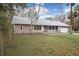 Charming single-story home featuring a welcoming front porch, attached garage and mature landscaping at 13289 Joy Path, Brooksville, FL 34601