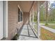 View of the home's covered front porch and beautiful mature landscape at 13289 Joy Path, Brooksville, FL 34601
