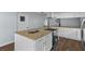 Modern kitchen island with granite countertop and stainless steel appliances at 13289 Joy Path, Brooksville, FL 34601