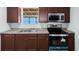 Close-up of kitchen with new appliances, brown cabinets, and speckled countertops at 13289 Joy Path, Brooksville, FL 34601