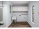 Laundry area with sink, cabinets, washer/dryer hookups, and updated flooring at 13289 Joy Path, Brooksville, FL 34601