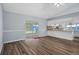 Open-concept living room featuring wood-look flooring and backyard access at 13289 Joy Path, Brooksville, FL 34601