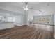 Expansive living room featuring a fireplace, windows, and an open layout to the kitchen at 13289 Joy Path, Brooksville, FL 34601