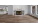 Bright living room featuring a white fireplace, light blue walls, and modern flooring at 13289 Joy Path, Brooksville, FL 34601