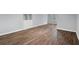 Bright living room featuring wood floors, a built-in storage unit, and a large window at 13289 Joy Path, Brooksville, FL 34601