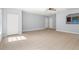 Bright living room with neutral tile, ceiling fan, and easy access to other rooms at 13289 Joy Path, Brooksville, FL 34601
