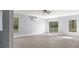 Bright living room with tile flooring, large windows, and a sliding glass door leading to the outdoors at 13289 Joy Path, Brooksville, FL 34601