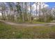 The property with a long driveway leads to the house surrounded by trees at 13289 Joy Path, Brooksville, FL 34601