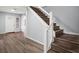 Bright entrance featuring wood flooring, white walls, and wooden stairs at 13289 Joy Path, Brooksville, FL 34601