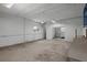 Unfinished workshop features fluorescent lighting, a ceiling fan, and a window air conditioning unit at 13289 Joy Path, Brooksville, FL 34601
