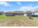 Expansive backyard featuring a well-maintained lawn, an outdoor fire pit, and space for recreation at 13419 Banner Rd, Spring Hill, FL 34609