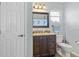 Bathroom featuring granite counters, vanity, and toilet at 13419 Banner Rd, Spring Hill, FL 34609