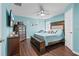 Beautiful bedroom with a ceiling fan, hardwood floors, and a decorative headboard at 13419 Banner Rd, Spring Hill, FL 34609