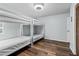 Bedroom featuring a bunk bed, neutral paint, and hardwood floors at 13419 Banner Rd, Spring Hill, FL 34609