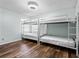 Bedroom featuring a bunk bed, neutral paint, and hardwood floors at 13419 Banner Rd, Spring Hill, FL 34609