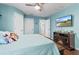 Bedroom with hardwood floors, TV, and decorative fireplace at 13419 Banner Rd, Spring Hill, FL 34609