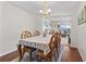 Bright dining room with wood floors, a stylish table setting, and view to the living room, ideal for Gathering gatherings at 13419 Banner Rd, Spring Hill, FL 34609