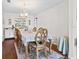 Elegant dining room with wood floors, a stylish table setting, and a charming chandelier, ideal for Gathering gatherings at 13419 Banner Rd, Spring Hill, FL 34609