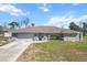 Charming single-story home featuring a well-manicured lawn and a spacious two-car garage at 13419 Banner Rd, Spring Hill, FL 34609