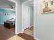 Hallway entrance leading to a bedroom featuring hardwood floors and neutral walls at 13419 Banner Rd, Spring Hill, FL 34609