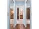 Hallway view looking into the bathroom between mirrored closet doors at 13419 Banner Rd, Spring Hill, FL 34609