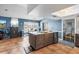 Kitchen features island with bar seating, tile floors, and stainless steel appliances at 13419 Banner Rd, Spring Hill, FL 34609