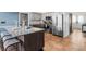 Open kitchen with island seating, stainless steel appliances, and granite countertops at 13419 Banner Rd, Spring Hill, FL 34609