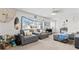 Bright living room featuring comfortable seating, neutral decor, and large windows that bring in plenty of natural light at 13419 Banner Rd, Spring Hill, FL 34609
