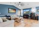 Inviting living room featuring stylish furniture, tiled flooring, and a modern entertainment center at 13419 Banner Rd, Spring Hill, FL 34609