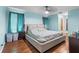 Serene main bedroom with hardwood floors, calming blue walls, and a spacious layout, creating a relaxing retreat at 13419 Banner Rd, Spring Hill, FL 34609