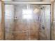 Glass enclosed shower with tiled surround, tiled shelves and sliding doors at 13419 Banner Rd, Spring Hill, FL 34609