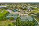 This aerial showcases the tennis and pickleball courts in relation to the clubhouse and parking at 18325 Whitacre Cir, Hudson, FL 34667