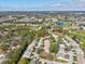 Aerial view of the home within a lush landscape, near a golf course and lake in Heritage Pines at 18325 Whitacre Cir, Hudson, FL 34667