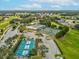 Community aerial view showcasing tennis, pickleball courts, and neighborhood layout at 18325 Whitacre Cir, Hudson, FL 34667