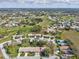 Aerial view of a neighborhood showcasing the home, community, and surrounding area with golf course at 18325 Whitacre Cir, Hudson, FL 34667