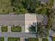 Aerial view of the property showing the roof, yard, driveway, and surrounding neighborhood at 18325 Whitacre Cir, Hudson, FL 34667