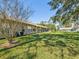 Expansive backyard featuring lush green grass and partial view of the rear of the home at 18325 Whitacre Cir, Hudson, FL 34667