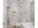 Bathroom with walk-in shower, tiled floor, and updated fixtures at 18325 Whitacre Cir, Hudson, FL 34667
