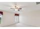 Spacious carpeted bedroom with ceiling fan and natural light from two windows at 18325 Whitacre Cir, Hudson, FL 34667