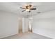 Spacious bedroom featuring neutral carpet and a ceiling fan with overhead lighting at 18325 Whitacre Cir, Hudson, FL 34667